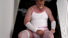 Diapered sissy in choker and chastity