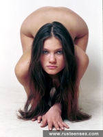 Teen brunette posing on the floor