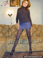Teen blonde in black pantyhose posing