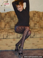 Teen blonde in black pantyhose posing