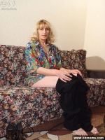Mature blonde shows shaved pussy