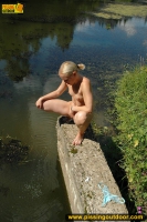 Pissing teen blonde pisses in the pool outdoor