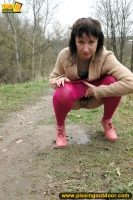 MILF brunette walks outdoor and pissing in the nature
