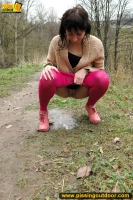 MILF brunette walks outdoor and pissing in the nature