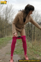MILF brunette walks outdoor and pissing in the nature