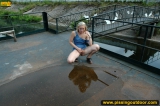Outdoor pissing on a village embankment