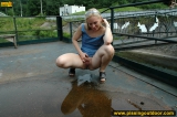 Outdoor pissing on a village embankment