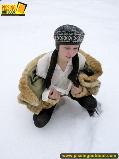 Pissing outdoor in the snow in winter day - N