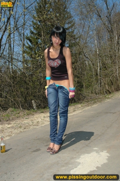 Teen brunette pissing on asphalt path outdoor - N