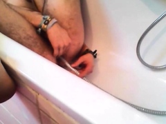 Bi-guy using shower head, squirting water, enema