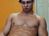 Muscular Guy in glasses jerking off and cumming