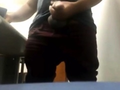 brazilian-daddy-strokes-his-big-uncut-cock-at-work